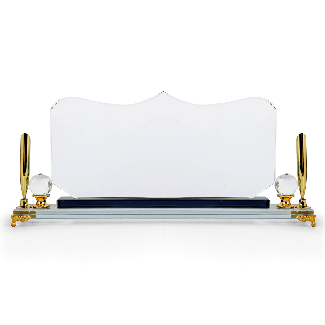 Crystal desk name plate with gold legs and pen holders on a white background