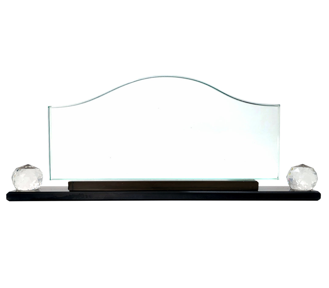 A crystal glass wave-shaped desk name plate with a placeholder for a name and title, displayed on a desk with the logo and name of a company above it.