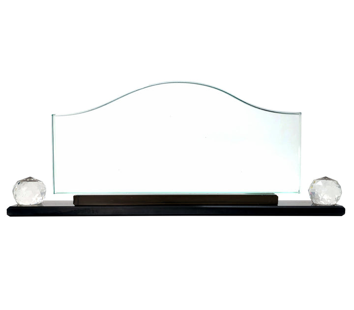 A crystal glass wave-shaped desk name plate with a placeholder for a name and title, displayed on a desk with the logo and name of a company above it.