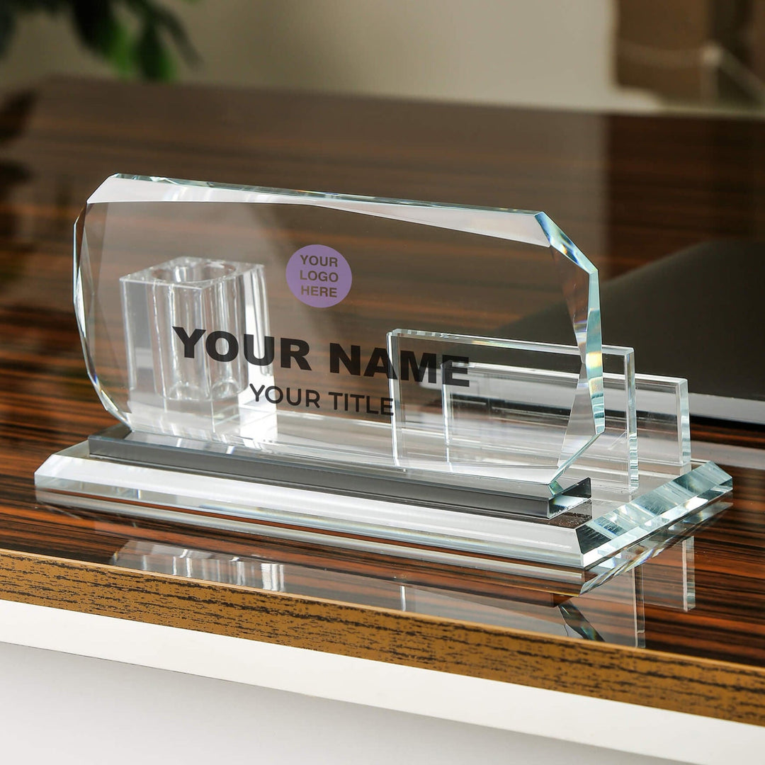 Clear glass nameplate holder on a wooden surface