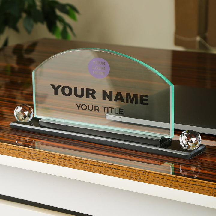 Glass nameplate with customizable text on a wooden stand