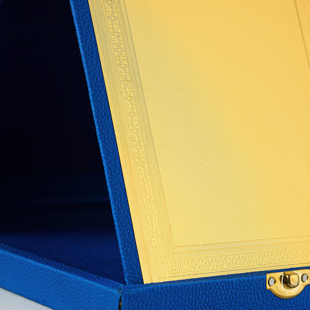 Close-up of a blue box with a gold lid featuring intricate patterns.