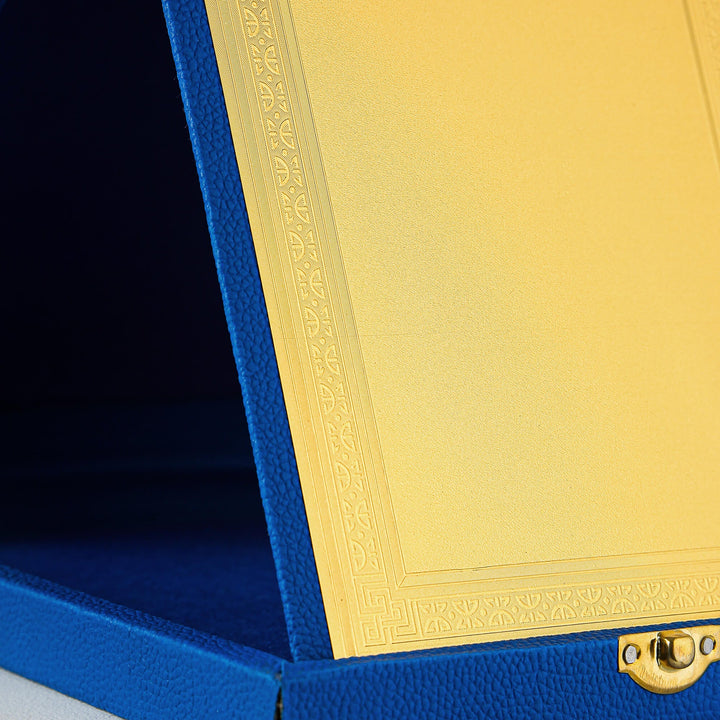 Close-up of a blue box with a gold lid featuring intricate patterns.