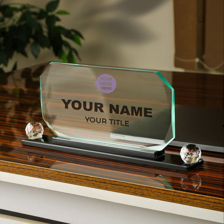Glass nameplate with customizable text on a wooden surface