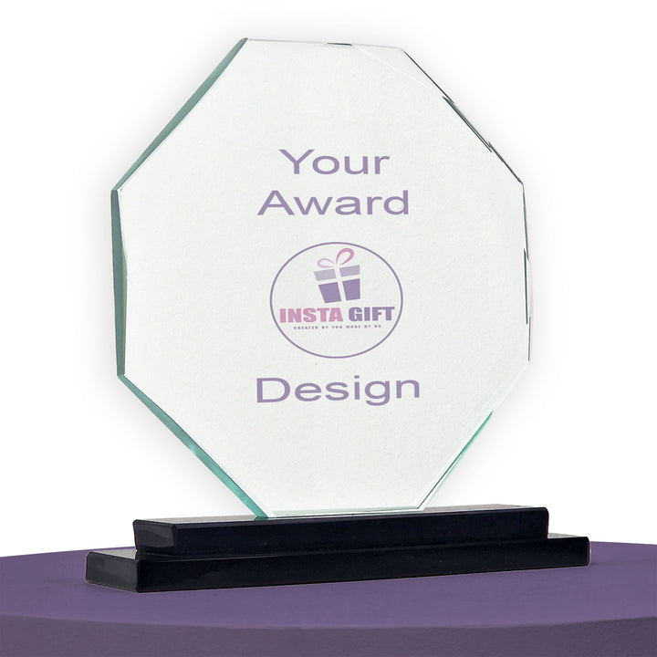 Clear glass award with 'INSTA GIFT' logo on a purple surface