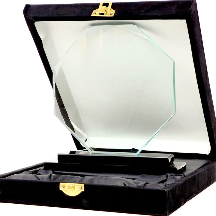 Glass award in a black display case with gold accents on a white background