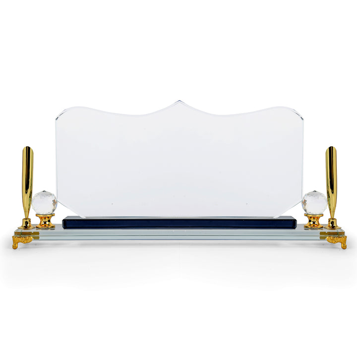 Crystal desk name plate with gold legs and pen holders on a white background