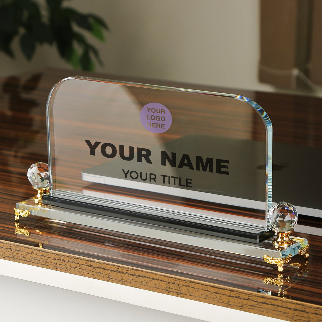 Personalised crystal desk nameplate on a crystal stand with decorative elements.