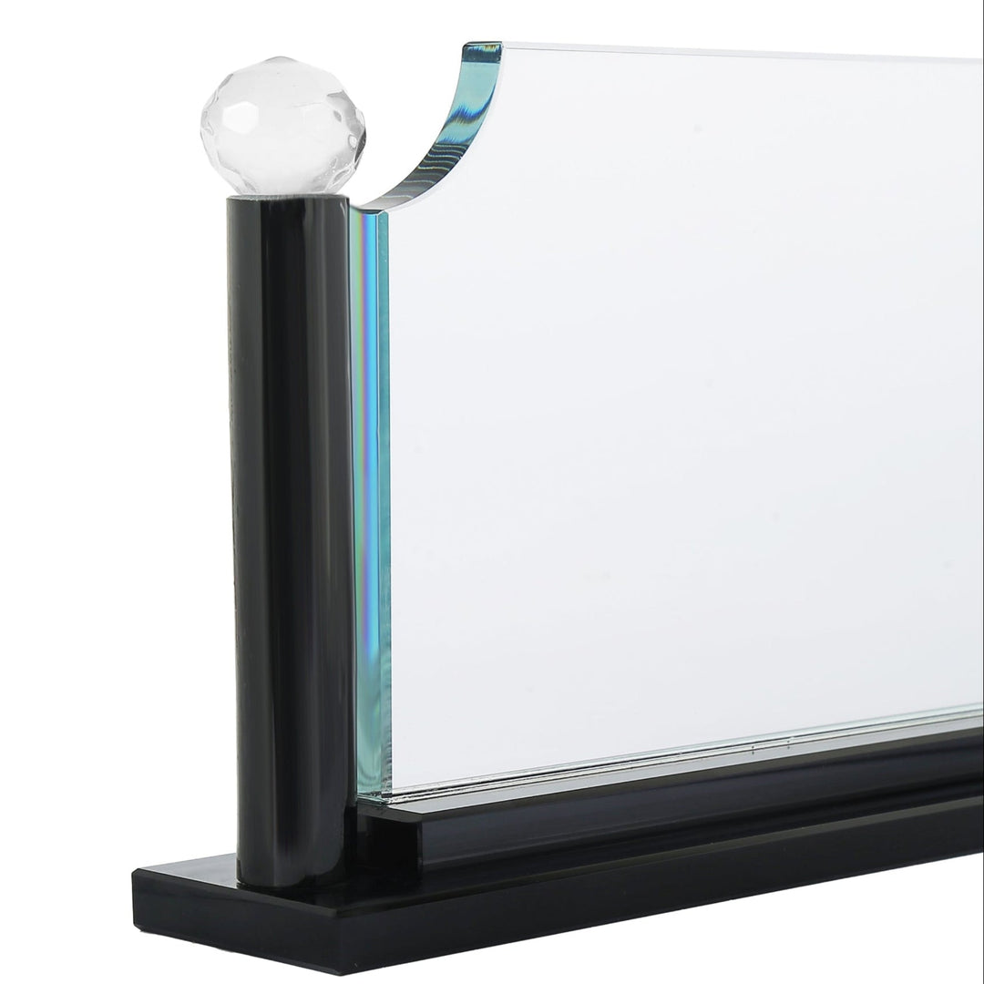 Glass panel with black frame and white sphere on a white background