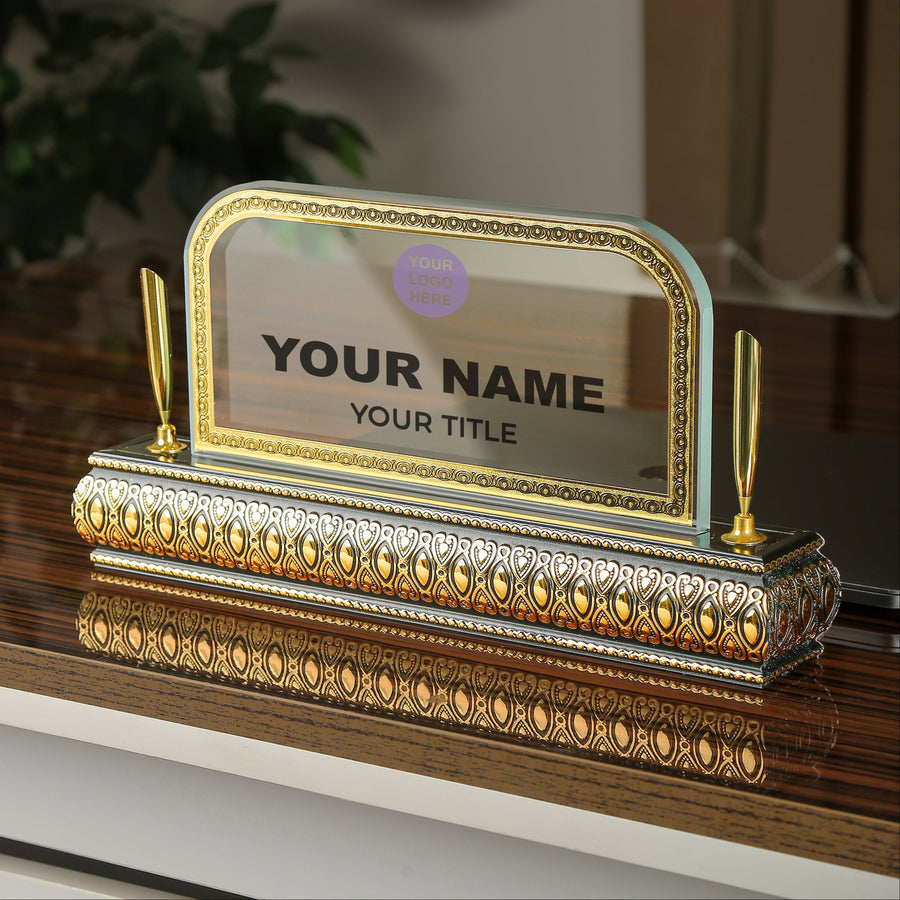 Decorative nameplate with gold accents on a wooden surface